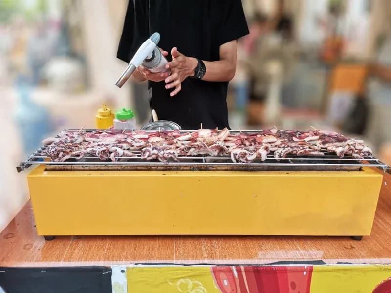 street-food-vendor-grilling-squid-satay
