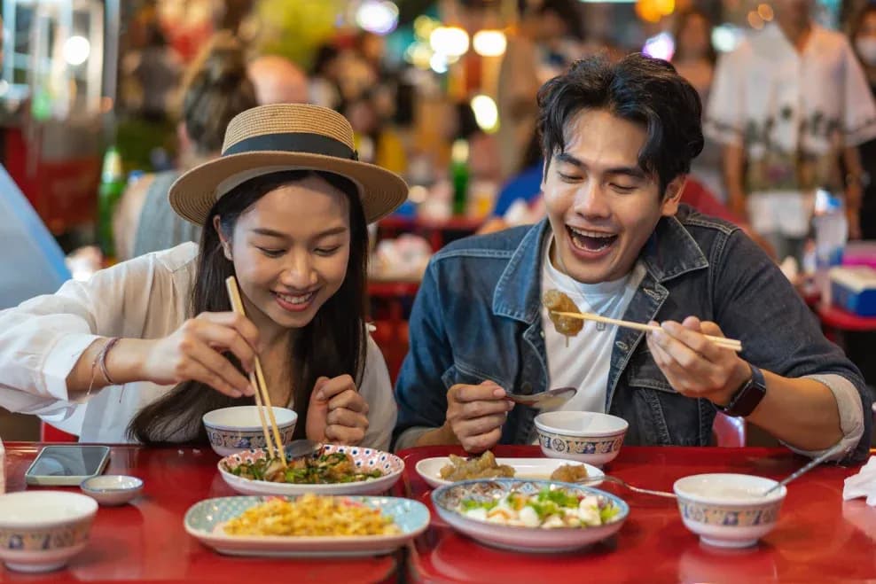young-asian-couple-traveler-tourists-eating
