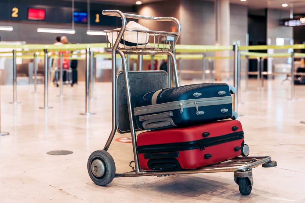 Luggage trolley with suitcases at an airport terminal check-in area