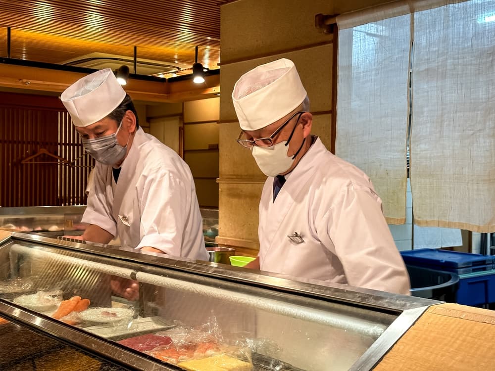 Omakase dinner. Sushi chefs preparing Sushi behind the counter of Restaurant